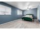 Bedroom with blue walls, ceiling fan, and two windows at 1578 W Campbell Ave, Phoenix, AZ 85015