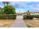 Inviting community pool area with clear pathways, lush landscaping, seating, and a welcoming atmosphere at 1578 W Campbell Ave, Phoenix, AZ 85015