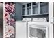 Clean laundry room with floral wallpaper, shelving, and a LG washer and dryer set at 1578 W Campbell Ave, Phoenix, AZ 85015