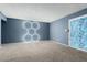 Bright living room featuring carpet flooring, stylish wall decor and sliding glass doors at 1578 W Campbell Ave, Phoenix, AZ 85015