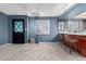 Open-concept living space featuring carpet, a statement door, and ambient lighting at 1578 W Campbell Ave, Phoenix, AZ 85015