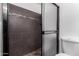 Modern shower with brown tiling, a pebble floor, and a glass shower door at 1578 W Campbell Ave, Phoenix, AZ 85015