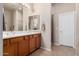 A large primary bathroom with double sinks, wood cabinets, and a glass enclosed shower at 16600 N Thompson Peak Pkwy # 1052, Scottsdale, AZ 85260