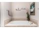 A bathtub in a neutral-toned bathroom with a large soaking tub and tile surround at 16600 N Thompson Peak Pkwy # 1052, Scottsdale, AZ 85260