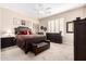 A well-lit main bedroom featuring plush carpeting and a luxurious, upholstered dark wood bed frame at 16600 N Thompson Peak Pkwy # 1052, Scottsdale, AZ 85260