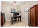 A home office with neutral walls, dark wood desk and cabinets, and a ceiling fan at 16600 N Thompson Peak Pkwy # 1052, Scottsdale, AZ 85260