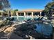 Resort-style pool area featuring luxurious lounge chairs, lush landscaping, and a beautiful clubhouse at 16600 N Thompson Peak Pkwy # 1052, Scottsdale, AZ 85260