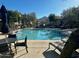 Beautiful community pool with lounge chairs and tables on a sunny day at 16600 N Thompson Peak Pkwy # 1052, Scottsdale, AZ 85260