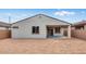 Back exterior of home showcasing backyard with concrete patio and desert landscaping at 16778 W Yucatan Dr, Surprise, AZ 85378