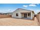 Back exterior of home showcasing backyard with concrete patio and desert landscaping at 16778 W Yucatan Dr, Surprise, AZ 85378