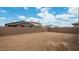 Backyard view showing desert landscaping and a block fence at 16778 W Yucatan Dr, Surprise, AZ 85378