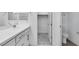A bathroom with dual sinks and access to the walk-in closet at 16778 W Yucatan Dr, Surprise, AZ 85378