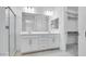 Bathroom with a double sink vanity, glass shower, and a walk-in closet at 16778 W Yucatan Dr, Surprise, AZ 85378