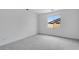 This is an empty bedroom with neutral carpet and a view out of the window at 16778 W Yucatan Dr, Surprise, AZ 85378