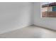 A bright bedroom features neutral tile flooring, ample natural light from a large window at 16778 W Yucatan Dr, Surprise, AZ 85378
