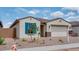 Charming single-story home with blue shutters, a desert landscaped yard, and a two car garage at 16778 W Yucatan Dr, Surprise, AZ 85378