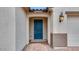 Close-up of the front entrance featuring a stylish blue door and welcoming entryway at 16778 W Yucatan Dr, Surprise, AZ 85378
