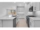 Bright, modern kitchen features white cabinetry, stainless steel appliances, and a sleek island at 16778 W Yucatan Dr, Surprise, AZ 85378