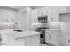 Bright, modern kitchen features white cabinetry, stainless steel appliances, and a sleek island at 16778 W Yucatan Dr, Surprise, AZ 85378