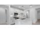 Bright, modern kitchen features white cabinetry, stainless steel appliances, and a sleek island at 16778 W Yucatan Dr, Surprise, AZ 85378
