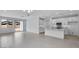 Open-concept living area featuring a kitchen with an island and neutral tile flooring at 16778 W Yucatan Dr, Surprise, AZ 85378