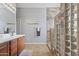 Bathroom with double vanity, tile floor, and walk-in shower at 17634 W Verdin Rd, Goodyear, AZ 85338