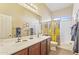 Bathroom features a double sink vanity and shower over tub combination at 17634 W Verdin Rd, Goodyear, AZ 85338