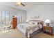 Bedroom featuring carpet, ceiling fan, and shuttered windows at 17634 W Verdin Rd, Goodyear, AZ 85338