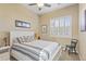 Bedroom with neutral walls, ceiling fan, and window with shutters at 17634 W Verdin Rd, Goodyear, AZ 85338