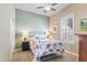 Bedroom boasts neutral walls, fan, and a window with plantation shutters at 17634 W Verdin Rd, Goodyear, AZ 85338