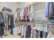 Walk-in closet with multiple tiers of shelving and hanging rods for organization at 17634 W Verdin Rd, Goodyear, AZ 85338