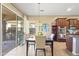 Bright dining area with a modern table, comfortable chairs, and sliding glass doors to the patio at 17634 W Verdin Rd, Goodyear, AZ 85338