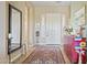 Elegant foyer featuring tile flooring, a stylish rug, and an ornate accent table at 17634 W Verdin Rd, Goodyear, AZ 85338