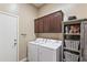 Laundry room includes front loading washer and dryer with storage at 17634 W Verdin Rd, Goodyear, AZ 85338