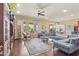 Cozy living room with hardwood floors, comfortable seating, and abundant natural light at 17634 W Verdin Rd, Goodyear, AZ 85338