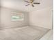 Bright bedroom featuring neutral carpet, a ceiling fan, and a window providing natural light at 18002 N 135Th Dr, Sun City West, AZ 85375