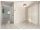 Bright dining area with tile flooring, a modern light fixture, and a doorway leading to another room at 18002 N 135Th Dr, Sun City West, AZ 85375