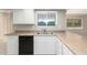 Kitchen features stainless steel sink, black dishwasher and white cabinets at 18002 N 135Th Dr, Sun City West, AZ 85375