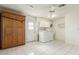 Bright laundry room featuring a Murphy bed, washer, dryer, utility sink, and ample storage space at 18002 N 135Th Dr, Sun City West, AZ 85375