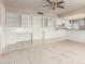 Open living room with neutral carpet, a ceiling fan, and views of the adjacent kitchen at 18002 N 135Th Dr, Sun City West, AZ 85375