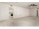 Spacious living room with neutral carpet and a view of the white kitchen through an open doorway at 18002 N 135Th Dr, Sun City West, AZ 85375