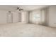 Inviting living room featuring a ceiling fan and large windows at 18002 N 135Th Dr, Sun City West, AZ 85375