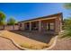 Covered patio and a backyard that has been landscaped with drought-resistant plants and artificial turf at 18750 E Ryan Rd, Queen Creek, AZ 85142