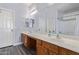 Bathroom featuring a double sink vanity, a large mirror and a tiled shower at 18750 E Ryan Rd, Queen Creek, AZ 85142