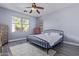 Bedroom with a ceiling fan, wood-look floors and natural light at 18750 E Ryan Rd, Queen Creek, AZ 85142