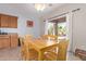 Bright dining area with a wood table, six chairs and access to the backyard at 18750 E Ryan Rd, Queen Creek, AZ 85142