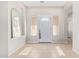 Bright foyer with neutral paint, tile floors, and a decorative mirror create a welcoming atmosphere at 18750 E Ryan Rd, Queen Creek, AZ 85142