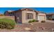 Landscaped front yard with desert-scape, decorative rocks, and manicured bushes in front of a single story home at 18750 E Ryan Rd, Queen Creek, AZ 85142