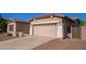 Beige two-car garage with white columns, exterior lantern sconces, and a large driveway at 18750 E Ryan Rd, Queen Creek, AZ 85142