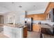 Bright kitchen featuring stainless steel appliances, tile floors, and a breakfast bar at 18750 E Ryan Rd, Queen Creek, AZ 85142